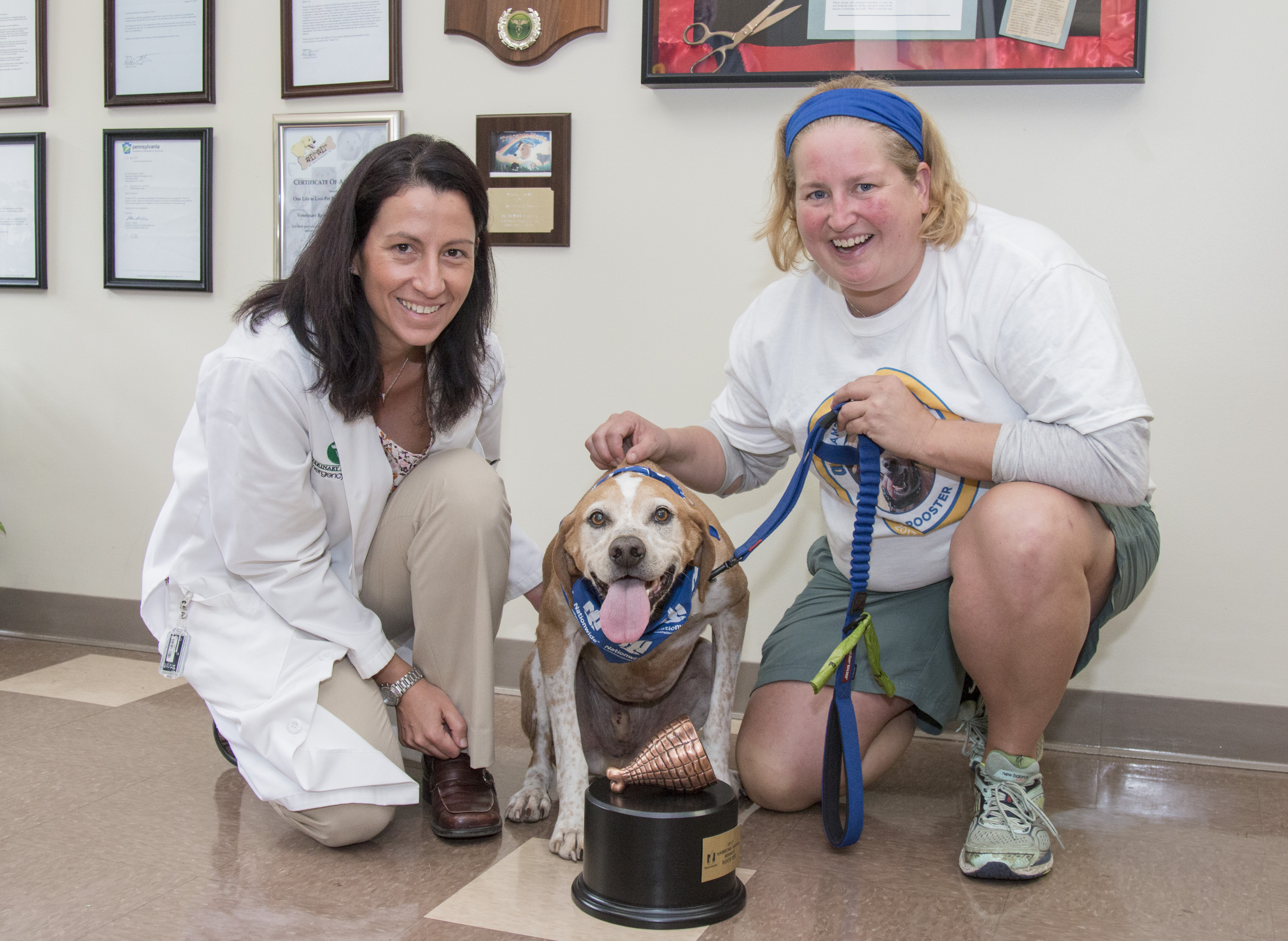 Doctor, pet owner, and award-winning dog smile for camera